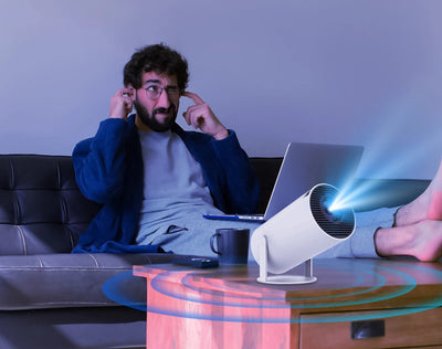 BARESY 4K outdoor home cinema projector on coffee table projecting blue light in living room with man on couch