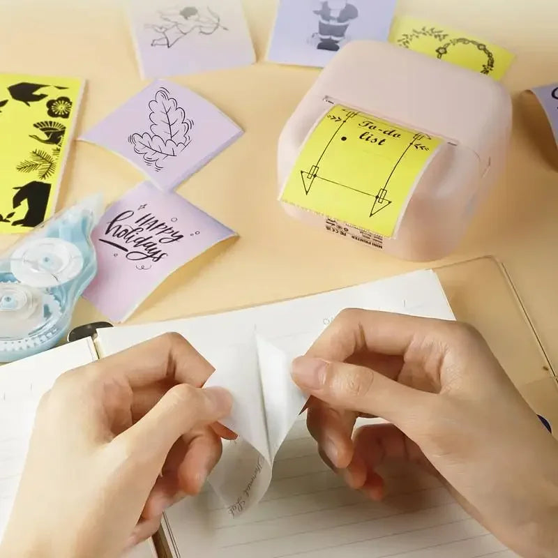 BARESY color mini printer sticker paper with pink portable printer printing yellow labels and hands peeling one