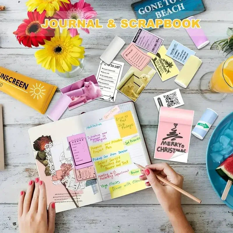 BARESY journal and scrapbook spread with hands writing and color mini printer sticker paper sheets