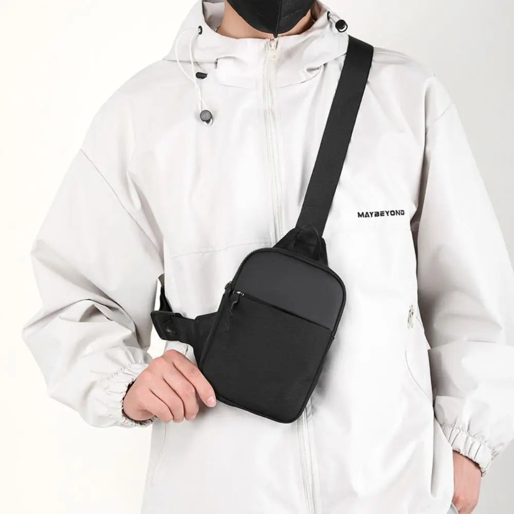 BARESY black minimalist crossbody pouch worn by model trendy chest bag for men with adjustable strap