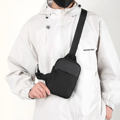 BARESY black minimalist crossbody pouch worn by model trendy chest bag for men with adjustable strap